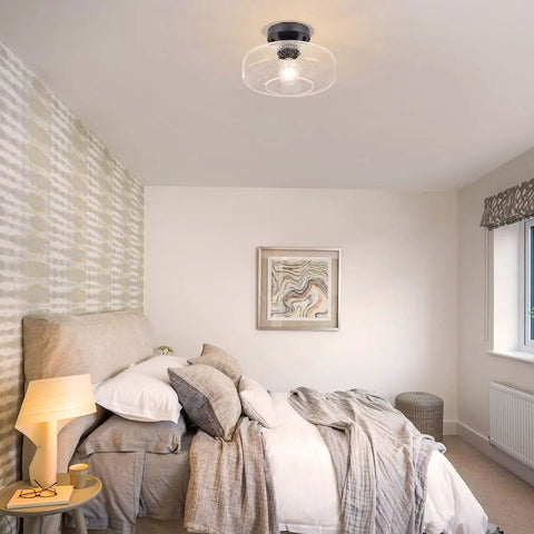 Bedroom with seeded glass shade flush mount ceiling light with matte finish for cozy modern vibe, showcasing retro charm.
