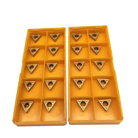 Front view of two yellow plastic organizers with 20 TCMT21.51 carbide turning inserts (triangular with center holes)