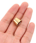 Brass Furniture Stabilizer Legs Four Pack For Mini Cabinets And Desks 10mm Decorative Riser Feet in hand close-up