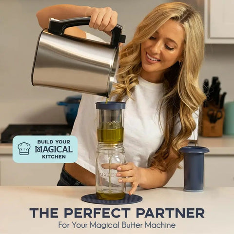 Woman using BPA-Free Reusable Oil And Butter Filter Press With Plunger And Brush to strain oil into jar in kitchen.