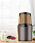 No Brainer Portable Bean To Cup Coffee Grinder And Spice Mill With Tap Control Quick Crushing Action Stainless Steel Bin displayed with ingredients.