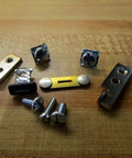 Contact Kit With All The Essentials Parts And Accessories For 15000001 Easy Install And Quick Fixes Plug And Play Setup For Smooth Operation And Reliable Performance. metal contact kit parts and screws on wooden surface