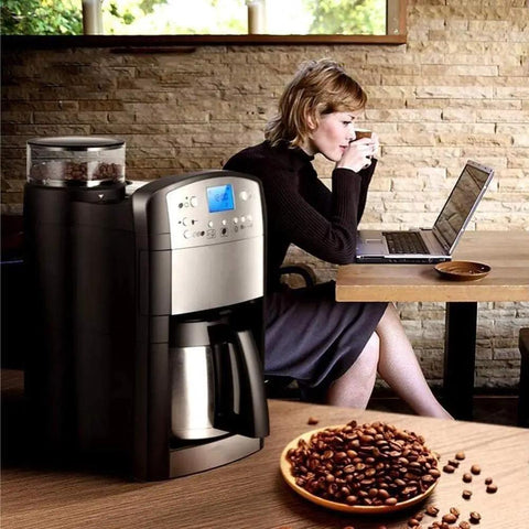 Coffee Maker Single Serve Espresso Machine With Blue Capsule Variety Pack For Office Kitchen And Home Use Quick Brews One Touch Operation Compact Desk Friendly Design Ideal For Breakrooms And Home Barista Fans next to a woman working in a cafe.