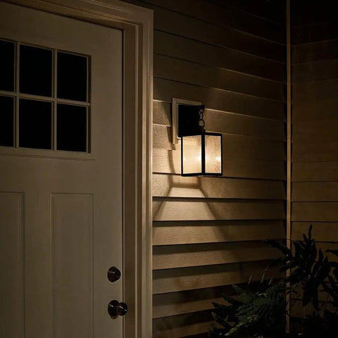 Lahden 16.75 Inch One Light Outdoor Wall Light With Clear Seeded Glass And Weathered Zinc Finish on house entryway at night