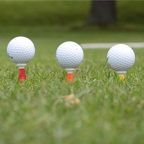 Flexible Fluorescent Golf Tees In Red Orange Yellow, 8 Pack, Assorted Sizes, holding golf balls on grass for smoother swing