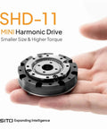 Compact Hollow Shaft Servo Reducer For NEMA 14 17 Motors 52mm Gearbox With Strain Wave Harmonic Drive in hand