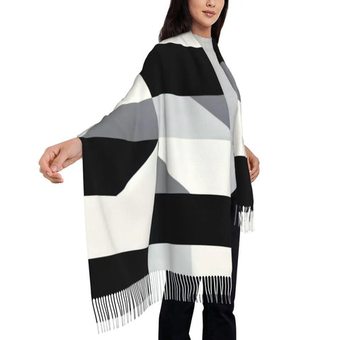 Black And White Piano Grid Winter Scarf Crafted From Plush Faux Cashmere With Extended Fringe Edges, worn elegantly with a hand out.