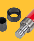 Close-up of a red hydraulic floor jack pump with metal piston and black and gray adapters.
