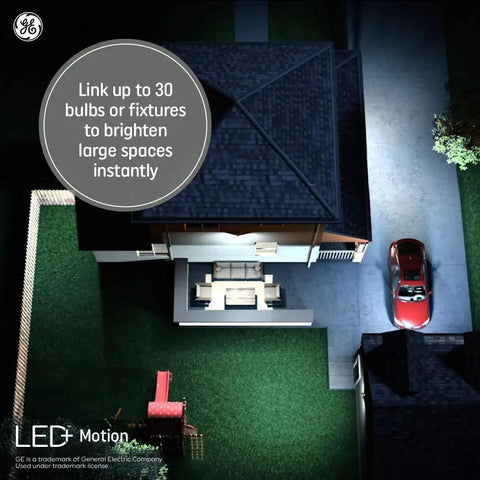 Nighttime aerial view of home driveway illuminated by Led Plus Linkable Outdoor Flood Light With Motion Sensor For Driveways And Patios.