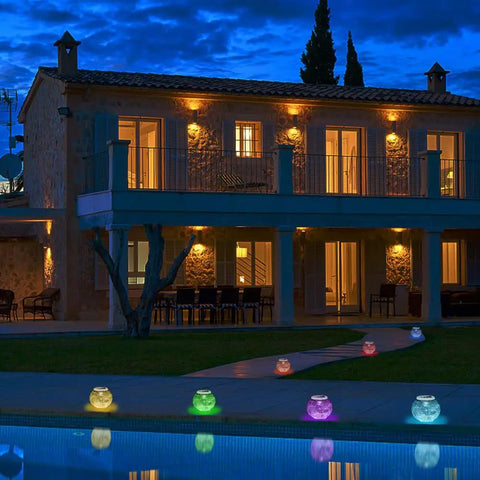 Color Changing Solar Powered Glass Ball Lights For Garden Patio And Indoor Decor along a walkway at dusk