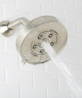 Neo Anystream 3 In 1 Shower Head With Self Cleaning Plungers Brushed Nickel Finish 2.5 GPM in use against white tile