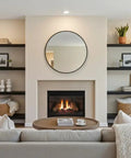 Cozy living room with beige couch, wood coffee table, modern fireplace, and black shelves displaying decor items.