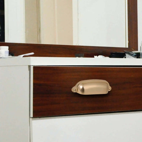 Chef Kiss 10 Pack 3 Inch Cup Kitchen Drawer Pulls With A Slick Champagne Gold Brushed Brass Finish Built Tough Using Solid Zinc Alloy Hardware For A No Sweat Cabinet Overhaul on a wooden drawer.