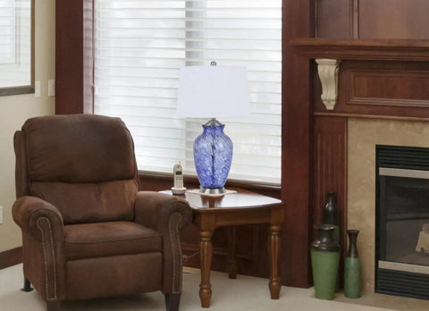28 Inch Sky Blue Hand Blown Glass Table Lamp with Ginger Jar Twist on a living room table, ambient daytime setting.