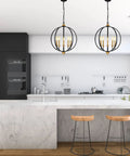 Five Light Farmhouse Pendant Lantern Chandelier In Black With Adjustable Height Chain over a modern kitchen island.