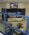 Indoor TV Enclosure for 42 to 50 inch screens mounted in a public space, showing a football game, secure locking and temperature control.