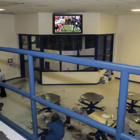 Indoor TV Enclosure for 42 to 50 inch screens mounted in a public space, showing a football game, secure locking and temperature control.
