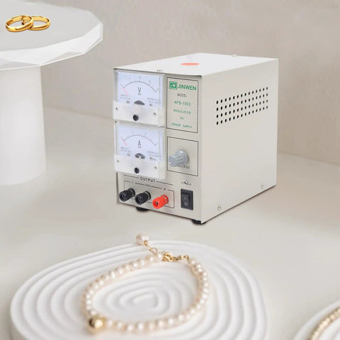 3A Electroplating Machine For Jewelry, 110V Pro Grade Gold And Silver Plating Power Supply with dials and jewelry on display.