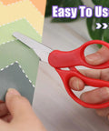 12 Pack 5 Inch Kids Safety Scissors With Blunt Tip cutting green paper, red handle, stainless steel blade, comfort grip