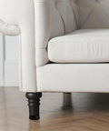 Couch with visible black furniture leg showcasing Heavy Duty Adjustable Furniture Leveling Legs Set 8 Pieces Rugged Carbon Steel and Nylon Construction