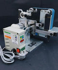 Heavy Duty 750W Brushless Belt Grinder A Real Garage Workhorse Built Tough In Rock Solid Steel Frame Forward Reverse Toggle Versatile Benchtop Sander And Polishing Kit with motor and blue sanding belt.