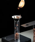 Glass Coffee Bean Storage Tubes Set Of Six With One Way Degassing Valve And Magnetic Stand And Single Dose Espresso Dosing Vials To Keep Your Java Fresh As A Daisy While Handling Your Essential Daily Grind Session, showcasing funnel pouring beans.