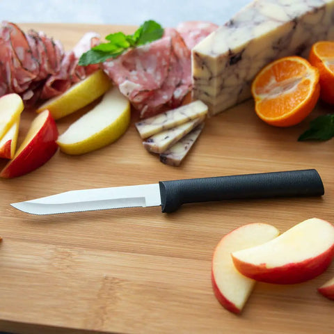 Built Tough Serrated Paring Knife Duo Featuring Premium High Carbon Stainless Steel Blades That Tear Through Tough Fruit And Veggie Skins Without A Sweat With Sleek Black Handles Pack Of Two on a wooden cutting board with sliced fruits.