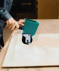 User applying glue with a Heavy Duty Portable Glue Roller With Smart Flow Control Switch For Even Woodworking Adhesive Coating And No Drama Diy Fix Projects All Year Long Using 180 Ml Tank Capacity.