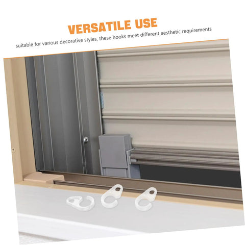 Three transparent curtain hooks next to a window showcasing installation, from 40 Pack Plastic Curtain Hooks for Shower and Window Drapery.
