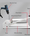 Detailed view of the manual shrink wrap heat sealer machine components including hot air gun, film rack, and adjustment panel.