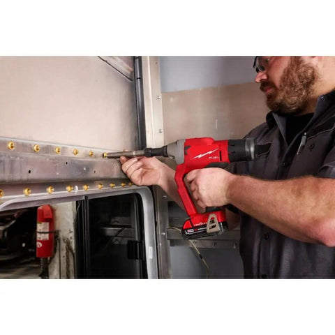 Person using One Quarter Inch Blind Rivet Tool With ONEKEY Kit For M18 FUEL Cordless Riveting Gun on metal surface