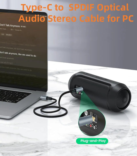 No Hassle Plug And Play Usb C Toslink Optical Audio Cable For Crisp Digital Sound Transfer Across Phones Laptops Smart Tvs And Home Theater Gear With Lossless Stereo Cord Four Feet Long connected to laptop and speaker.