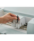 Hand inserting Deep Point Blade and Housing for Craft Cutting Machines With Deep Cut Capability into Cricut machine.