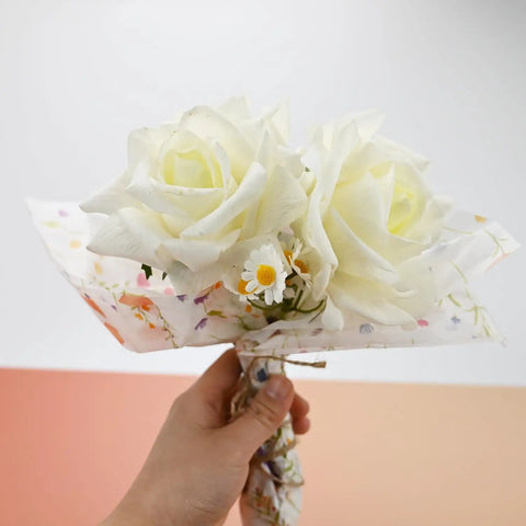 Hand holding bouquet wrapped in Flower Gift Wrapping Tissue Paper Set 100 Sheets Eco Friendly Recyclable Greenery Botanical Design