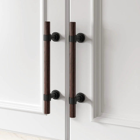 10 Pack 5 Inch Hole Center Cabinet Pulls With Authentic Wood Grain Look And Charcoal Black Zinc Body Designed With Heavy Duty Stainless Steel Construction Drawer Knobs That Feel Rock Solid And Next Level Hardware on a cabinet door.