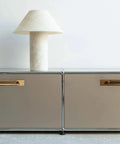 Antique Brass Zinc Alloy Cabinet Handle With Backplate 5 Inch Hole Center installed on modern cabinets with decorative lamp.