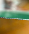 Close-up of No Nonsense Heavy Duty Reflective Emergency Assembly Point Sign's aluminum edge highlighting durability.