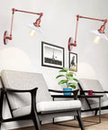 Top Tier Adjustable Swing Arm Wall Sconce With Hand Blown Glass Shade And Hella Bright Up Down Ambient Glow E27 Bulb Suits Bedroom Bedside And Study Reading In Cool Green Bronze over two chairs in a living room.
