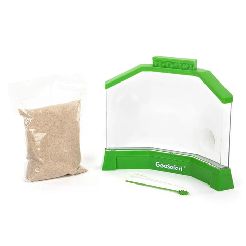 Ant Factory Classroom Ant Farm With Live Ants For Hands On STEM Learning At Home Kids Science Kit Escape Proof Habitat With Large Viewing Area Magnification Spots And Feeding Tool, empty clear plastic habitat with green edges and a bag of sand