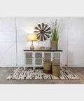 Living room scene with Gourd Glass Table Lamp with Silver and Gold Crackle Finish on a sideboard, round shade lit.