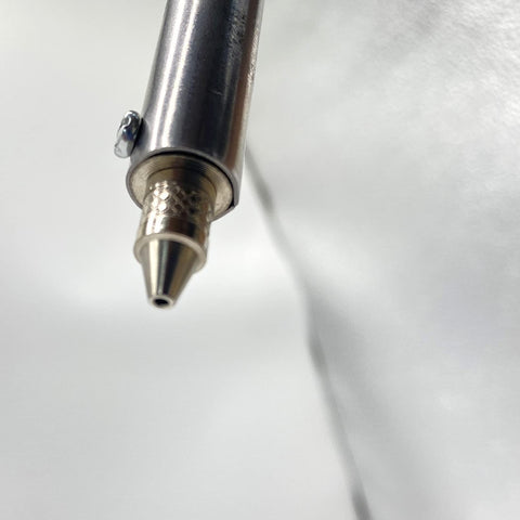 Close-up of nozzle on Automatic Desoldering Pump Vacuum Solder Sucker Tool For DIY AC110V 30W Electric Desoldering Gun.