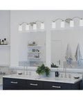 Inspire Collection Four-Light Bath Vanity Light with Etched Glass Shades in Brushed Nickel Finish over a modern bathroom sink.