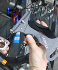 Premium Aluminum Alloy Bicycle Spoke Tension Meter Insanely Accurate Road Bike Wheel Building Tool in use on bicycle spokes.