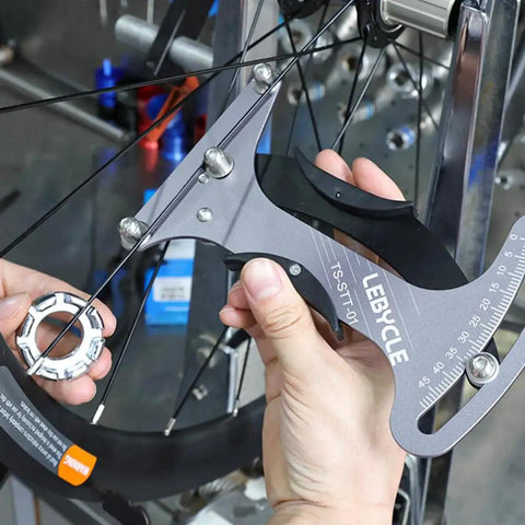 Premium Aluminum Alloy Bicycle Spoke Tension Meter Insanely Accurate Road Bike Wheel Building Tool in use on bicycle spokes.