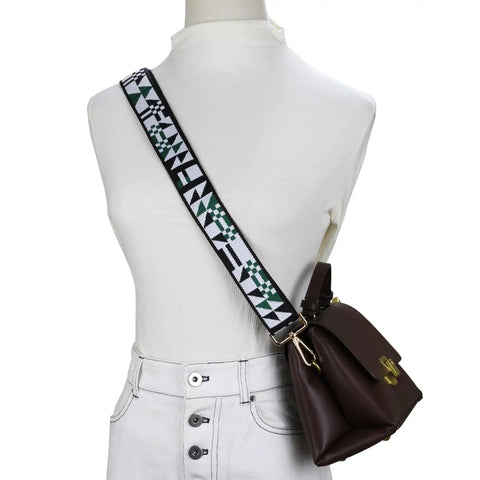 Slap This Wide Adjustable Jacquard Purse Strap On Any Bag For Major Crossbody Vibes And Watch It Slay With Premium Gold Hardware In Chic Triangular Green on a model with a brown bag.