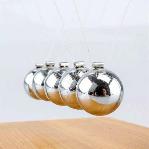 Hands On Newton Collision Ball Pendulum Lab Kit For Momentum And Kinetic Energy Conservation, close-up of metal spheres in motion