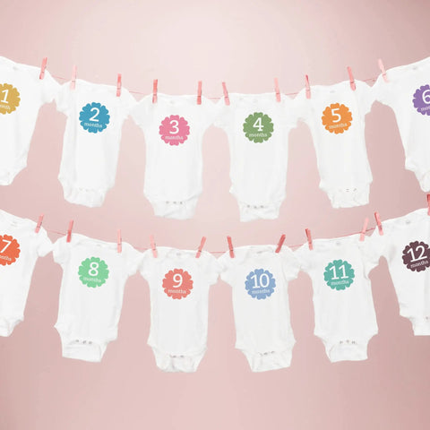 White onesies with month numbers hanging on a pink background, each marked 1-12 months; light t shirt transfers 8938 pack of 18 for white.