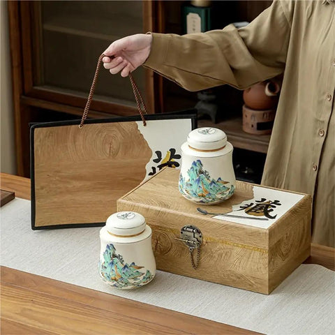 Vintage Airtight Ceramic Double Tea Canisters For Loose Leaf Coffee Beans And Spices on a wooden counter with a decorative box.