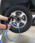 Person using Heavy Duty 3/8 Inch Rubber Air Hose 300 Feet Long 300 PSI with impact wrench on tire.