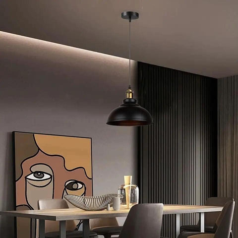 Black Industrial Metal Pendant Light, E26 Curvy Adjustable Ceiling Fixture hanging over a modern dining table with artistic decor.